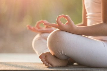 calmness and relax, female happiness.horizontal, blurred background. little asian girl meditates whi