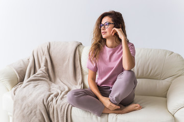 Wall Mural - Young attractive woman dressed in beautiful colorful pajama posing as a model in her living room. Comfortable sleepwear, home relaxation and female fashion concept.