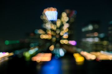 Canvas Print - Blur of City at night with light bokeh and water reflection