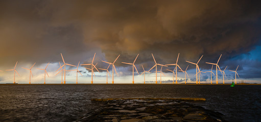 Wall Mural - offshore wind farm at beautiful, dramatic sunset