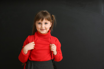 Poster - Cute little schoolgirl near blackboard in classroom