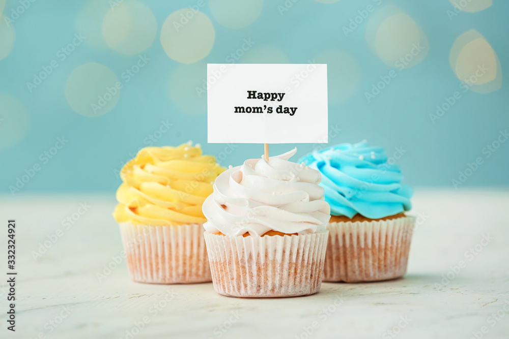 Tasty cupcakes for Mother's Day on table