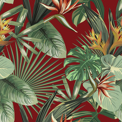 Wall Mural - Exotic flowers tropical green leaves seamless red background