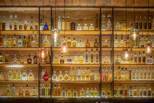 Defocused Background Of Bar Counter With Various Bottles Of Alcohol.
