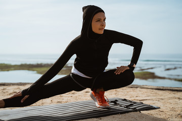 Wall Mural - attractive sport muslim woman with hijab exercise outdoor