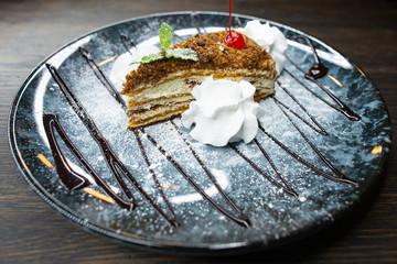 delicious honey dessert with chocolate, whipped cream and mint leaves