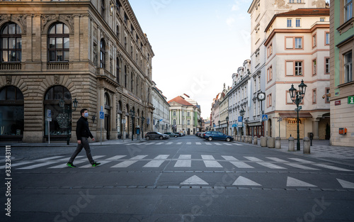 Fotomural Prague, Czech republic - March 17, 2020: Man with the mask is walking in the historical centre in Prague after coronavirus pandemic