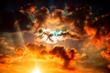 Wall Mural - day comes after night. colorful sunset, sunrise. majestic clouds in the sky and light rays.