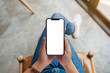 © Farknot Architect - Top view mockup image of a woman holding mobile phone with blank white screen