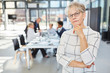 © Robert Kneschke - Thoughtful senior woman as boss in the meeting in the office
