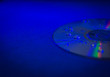 CD disk with droplets of water in blue light close-up