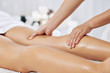 © DragonImages - Hands of massage therapist massaging legs of young woman in spa salon