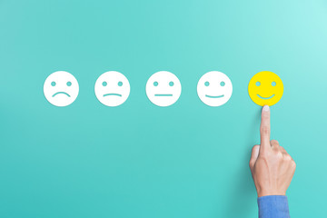 client's hand picked the happy face smile face, customer service evaluation and satisfaction survey 