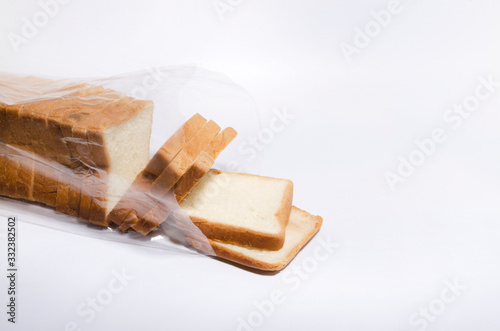 Cuadros en Lienzo Opened plastic bag full of slices of white bread on the white background