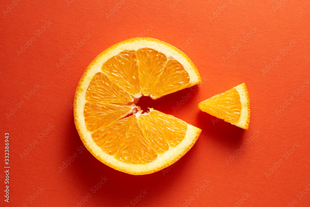 Orange slice symbolizing vitamin c is eating the cut out piece on orange background - obrazy, fototapety, plakaty 