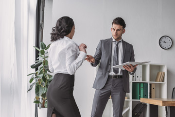 sexy secretary showing her breasts to shocked businessman holding papers