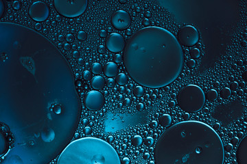 dark blue abstract background, bubbles in transparent liquid