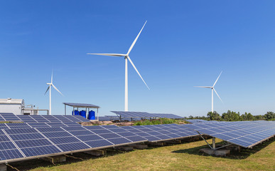 Wall Mural - solar cells or solar panels or photovoltaic cells with wind turbines generating electricity alternat