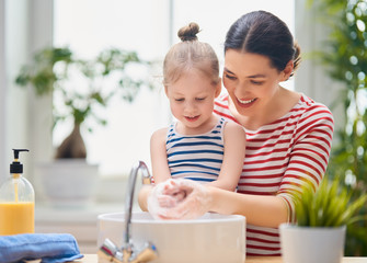 Wall Mural - girl and her mother are washing hands