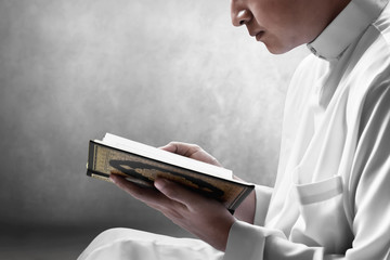 Religious muslim man reading holy quran