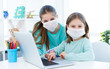 © Ievgen Skrypko - Girls studying at home using laptop during coronavirus pandemic