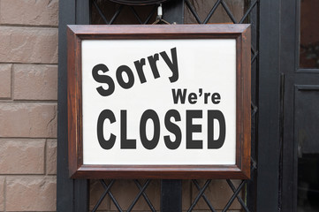 Wall Mural - sorry we are closed sign hanging outside a restaurant, store, office or other