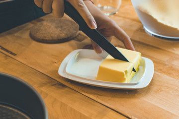 Butter. Slice of butter. Fresh sliced butter on the wooden plate.