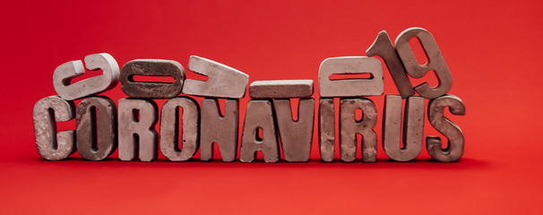 inscription from the letters 3D coronavirus covid 19 on a red background in isolation pandemic virus