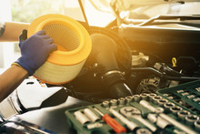 Cropped Image Of Handsome Young Auto Mechanic In Uniform Repairing Car Change Car Air Filter In Auto Service.selective Focus.