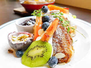 Wall Mural - Delicious sweets French toasts with vanilla yogurt, blueberries jam and fresh fruits for a vitamin breakfast.