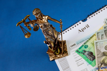 Wall Mural - Concept of non-payment of taxes criminal liability lady justice of one hundred dollar bills U.S. INDIVIDUAL INCOME TAX RETURN FORM 1040