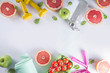 © ricka_kinamoto - Fitness and healthy food lifestyle concept. Dumbbells, diet fruit and vegetable lunch box, water and jump rope on white background. Flatlay image, top view copy space
