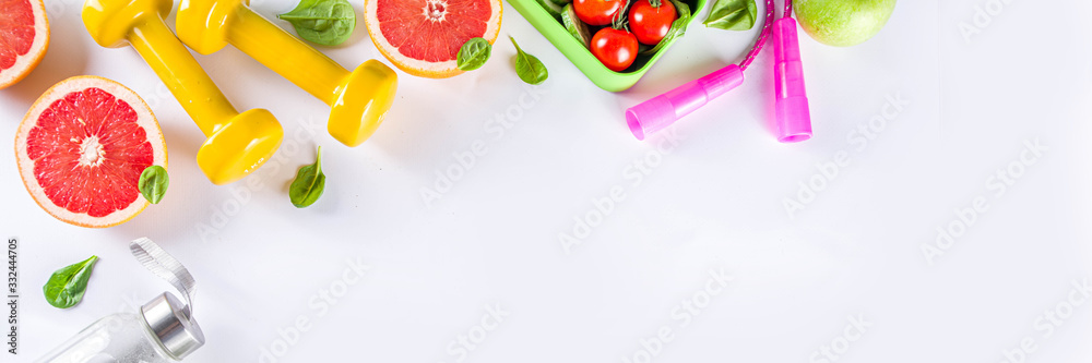 Fitness and healthy food lifestyle concept. Dumbbells, diet fruit and vegetable lunch box, water and jump rope on white background. Flatlay image, top view copy space - obrazy, fototapety, plakaty 