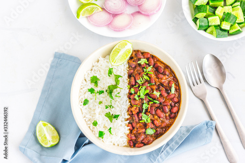 Indian Rajma Chawal in a Bowl on White Background with Lemon, Cucumber and Onion Top View Horizontal Stock Photo