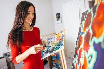 Wall Mural - girl with long hair draws an oil painting