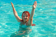 © finist_4 - A young woman with African pigtails stands in the water in the pool.