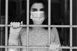 © federico neri - Coronavirus in Italia: una ragazza protetta dalla mascherina si affaccia dall'inferriata della sua finestra