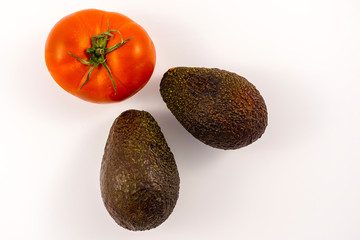 Wall Mural - Two good avocados and one tomato. Recipe to make a nice guacamole