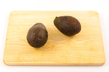 Wall Mural - Two good avocados on a wood. Recipe to make a nice guacamole