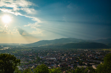 Wall Mural - Epic panorama of a small town locating in a valley among the mountains