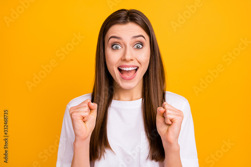 Closeup photo of crazy pretty lady long perfect hairstyle listen amazing news open mouth raise fists celebrate lottery win wear casual white t-shirt isolated vivid yellow color background