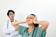 © oqba - young asian malay chinese male female doctor on white background headache angry annoyed hand on head scream