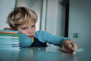 Wall Mural - little boy tired stressed of reading, doing homework