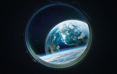 view on earth planet from porthole of space station. blue planet and space. elements of this image f