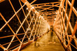 © Alex Salcedo/ADDICTIVE STOCK - Metal illuminated bridge construction and people walking on bridge in Girona, Catalonia, Spain