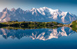 © Javier Martinez/ADDICTIVE STOCK - Range of white snowy peaks and hilly seaside reflecting in clear motionless lake in sunny day in Chamonix, Mont-Blanc