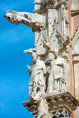 Poster - gargoyles and saints on facade of Siena Cathedral (Duomo di Siena) is a medieval church, now dedicated to the Assumption of Mary, completed between 1215 and 1263, Siena, Italy