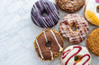 © Peter Karasev/ADDICTIVE STOCK - Variety of doughnuts on marble background