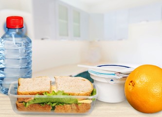 Poster - Lunch box with sandwiches, fruits and water on the desk