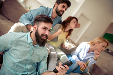 Poster - Young friends drinking beer and watching tv at home